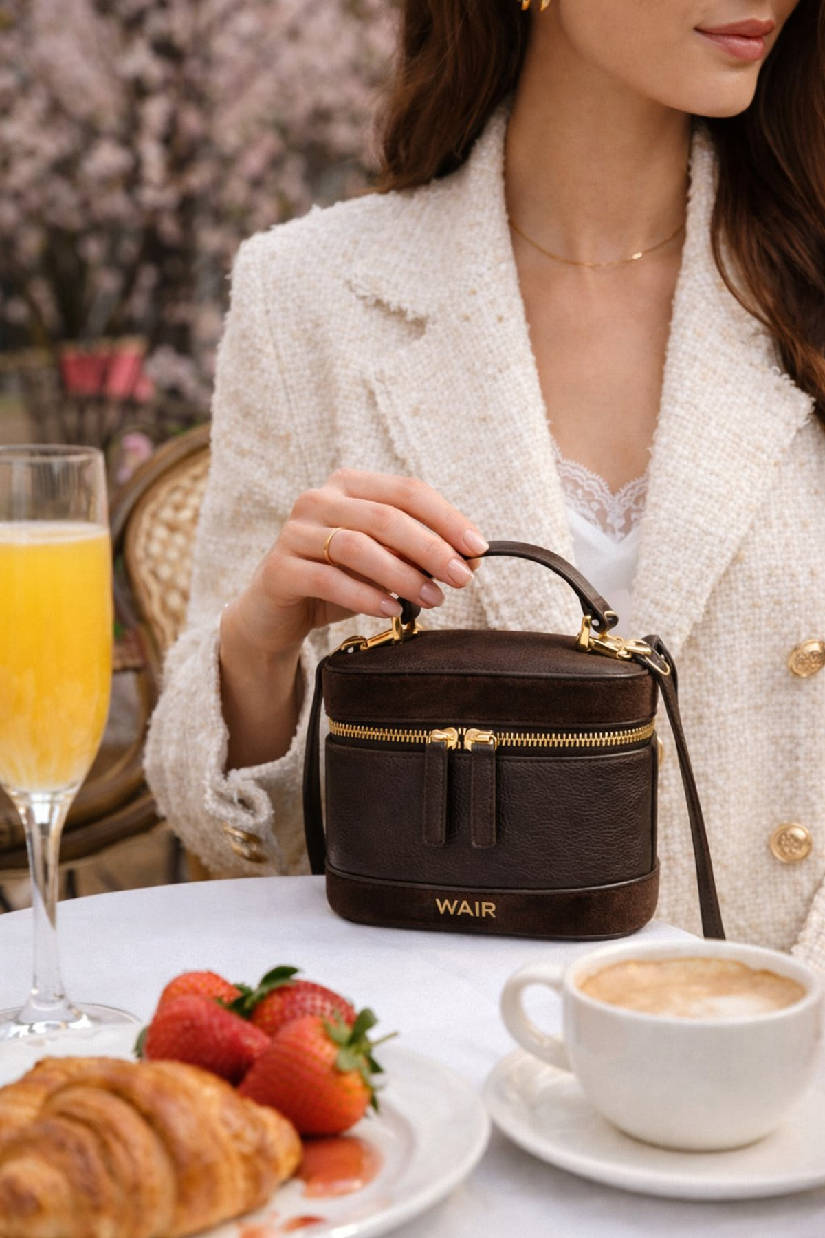 The Locket on a cafe table, held beside a brunch setting