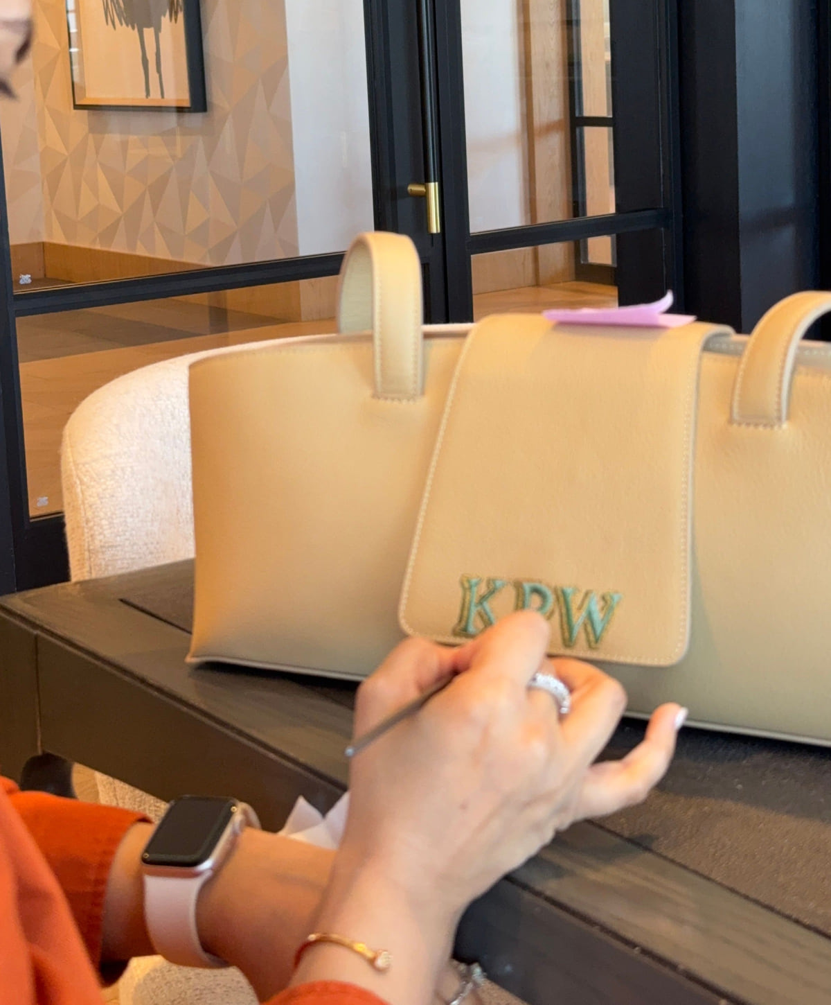Annem’s hand and brush working on KPW initials on a Canvas Sloane